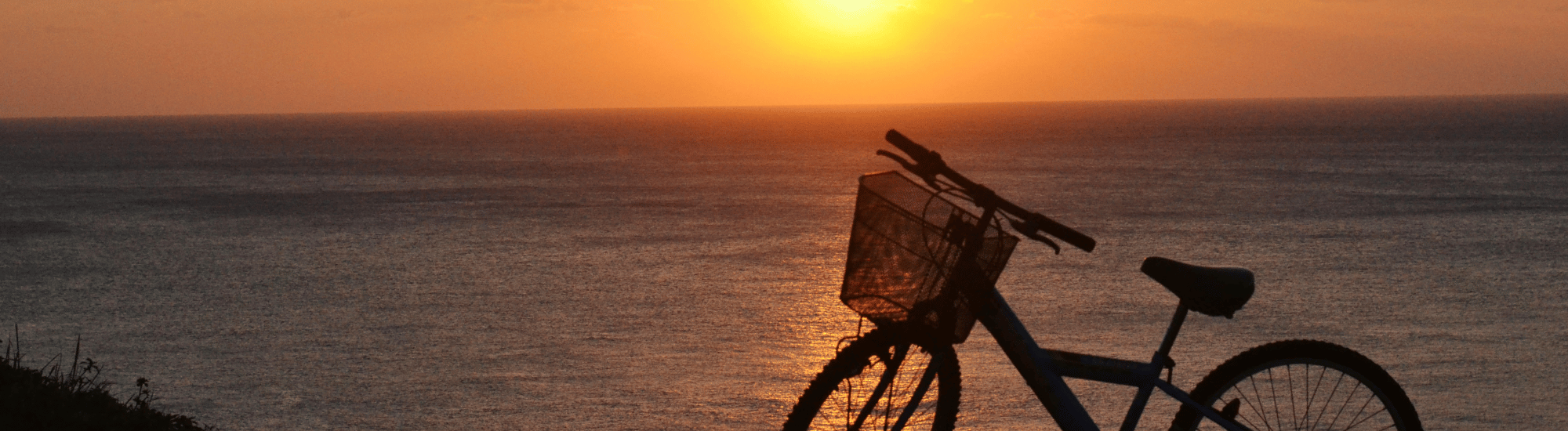 Bicycle on the beach at sunset