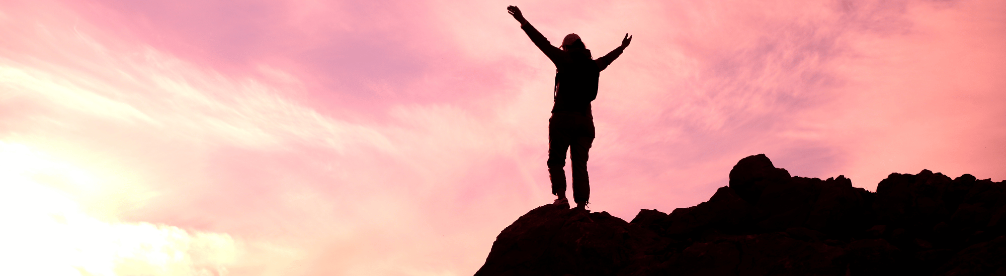 Happy person standing on cliff